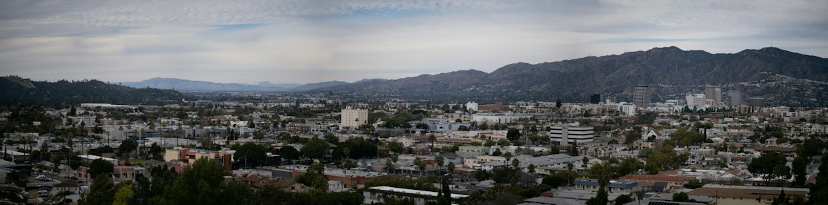 A panorama across Glendale, with mountains behind the city.