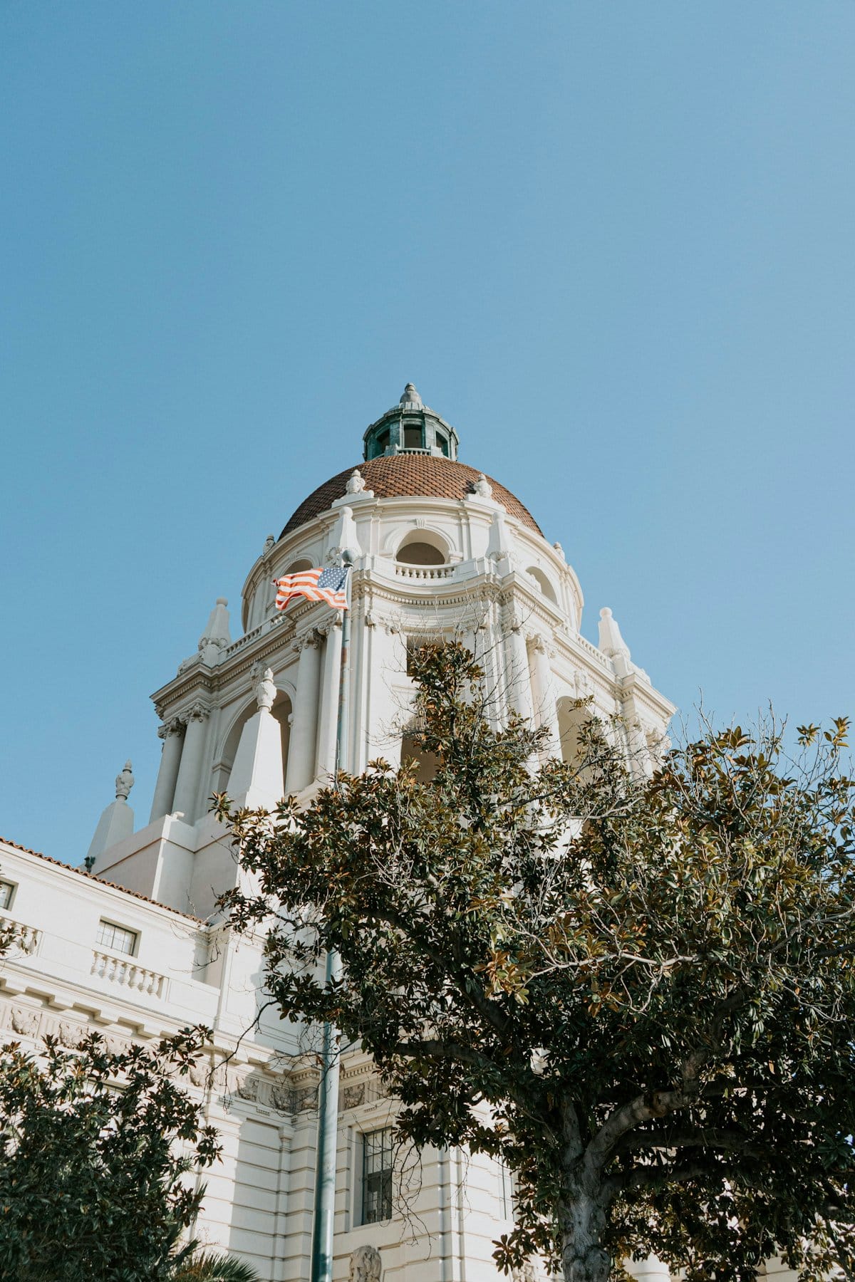 Pasadena City Hall, its dome and arches under a clear blue sky.