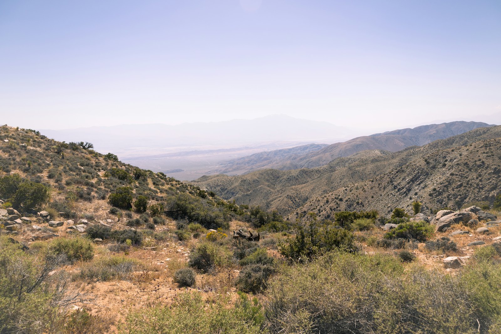 A mountain range seen across open ground on a clear day.