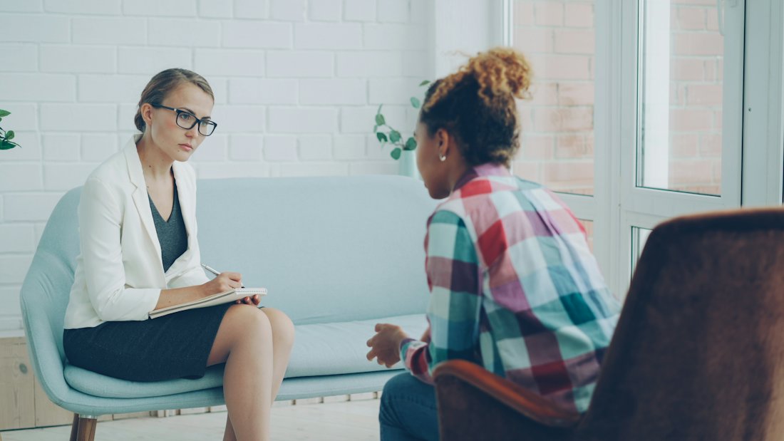 A therapist listening to a client during a counseling session.